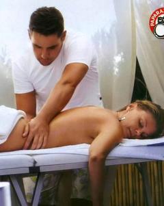 Patrizia Pellegrino getting massage on a beach