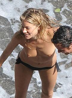 Sienna Miller caught topless on a beach