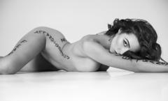 Olivia Culpo lying naked