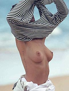 Eliza Cummings topless on a beach