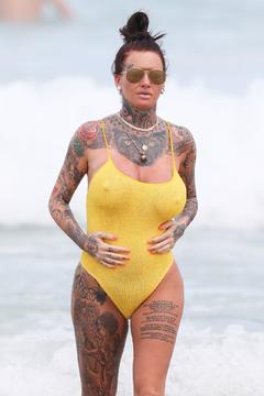 Jemma Lucy pokies in yellow swimsuit on the beach in Sydney