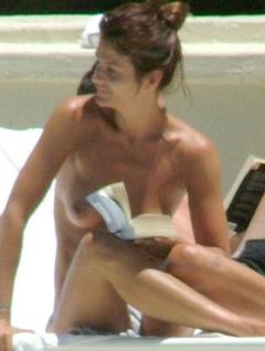 Helena Christensen topless reading book at a beach
