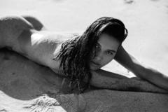 Lisa Marie Bosbach lying naked on a beach