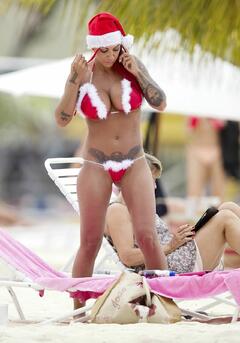 Jodie Marsh shows off her Santa-themed bikini while relaxing on the beach in Barbados