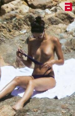 Rocio Morales sunbathing topless on a beach paparazzi photo