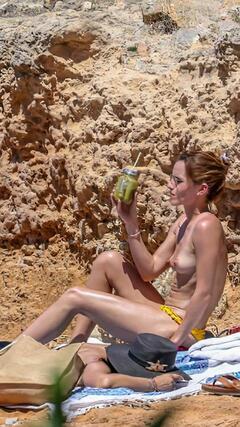 Emma Watson topless on a beach