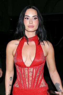 Demi Lovato in red dress attending OBB Media holiday party in West Hollywood - December 13, 2025