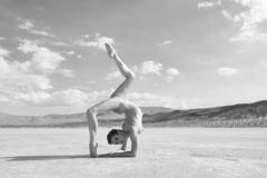Nina Burri doing yoga nude in a desert black-&-white image