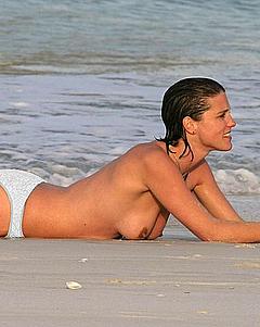 Heather Peace sunbathing topless