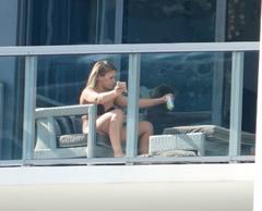 Paige VanZant in bikini tanning on her hotel balcony in Miami
