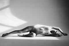 Sasha Smelova lying fully nude black-&-white image