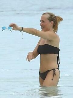 Gillian Anderson wearing a black bikini on the beach in Tulum - October 2024