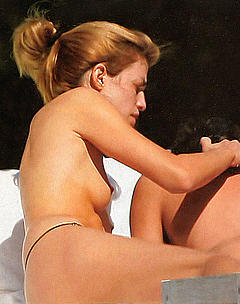 Daniela Urzi caught topless on a beach