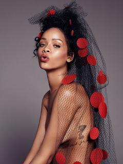 Singer Rihanna topless but covered