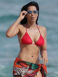 Padma Lakshmi in red bikini on a beach