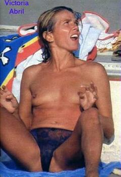 Victoria Abril sunbathing topless on a beach