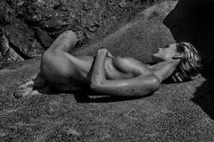 Edita Vilkeviciute lying naked on a sand