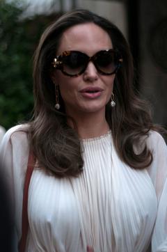 Angelina Jolie pokies in white dress in Paris