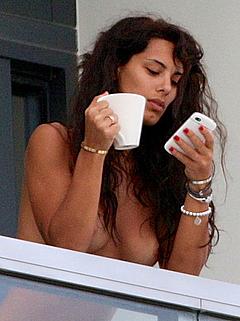 Italian Raffaella Modugno topless on a balcony