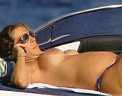 Fiona Swarovski sunbathing topless on a yacht