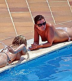 Kate Lawler sunbathing topless poolside