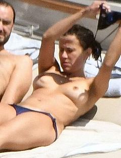 Sophie Marceau tanning topless on a yacht