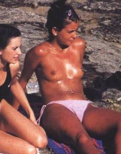 Monica Cruz sunbathing topless on a beach with her sister