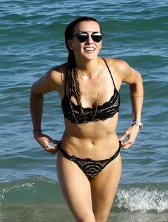 Katie Cassidy in black bikini on a beach
