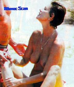 French actress Corinne Clery topless on a beach paparazzi photo
