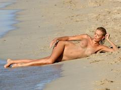 Orlaith McAllister lying nude on a beach