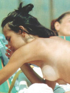 Antonella Mosetti topless on a beach
