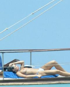 Manuela Arcuri sunbathing topless on a yacht paparazzi image