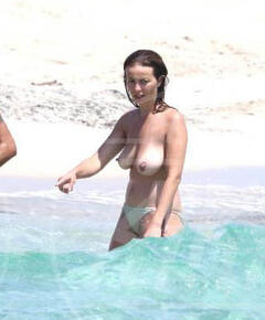 Violante Placido flashing her nude tits on a beach