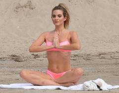 Rachel McCord in pink bikini doing yoga on the beach in Venice