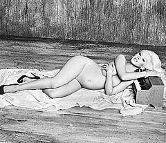 Pregnant Christina Aguilera lying nude cover her boobs