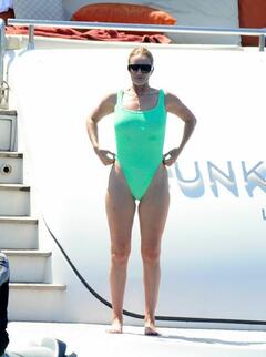 Rosie Huntington-Whiteley in green swimsuit on a yacht in Formentera