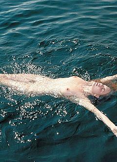 Camille Rowe fully nude in a water