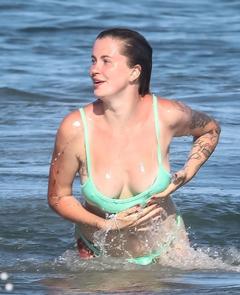 Ireland Baldwin in green bikini on the beach in Malibu