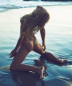 Marisa Papen posing fully nude on a beach