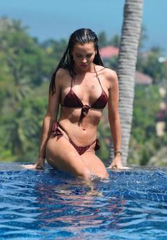 Shelby Tribble pokies in poolside in a bikini in Thailand