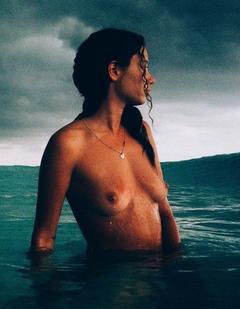 Maya Singer topless in a water