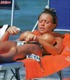 Busty Finnish-Italian model and film actress Anna Falchi sunbathing topless