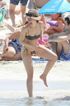 Aurora Ramazzotti showcases her svelte physique in her skimpy black bikini on the beach in Formentera