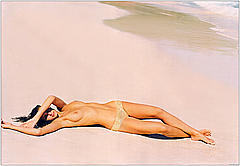 Reka Ebergenyi lying topless on a beach