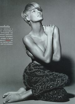 Blonde Linda Evangelista topless cover her breasts