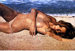 Daria Werbowy lying topless on a beach