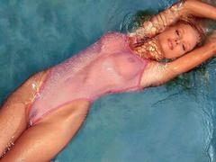 Michelle Hunziker in wet see through bodysuit in a pool