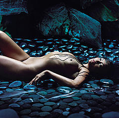 Tia Carrere lying fully nude in a water