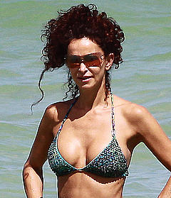 Sofia Milos cleavage in bikini on a beach