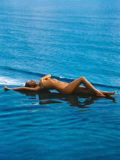 Bryana Holly lying naked cover her tits